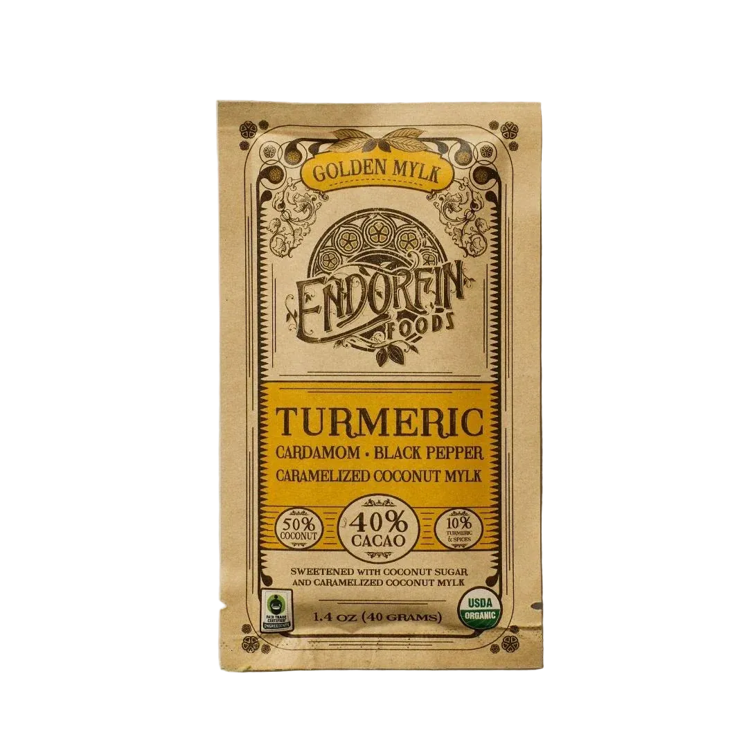 Golden Mylk Chocolate Bar, front of package on cream surface