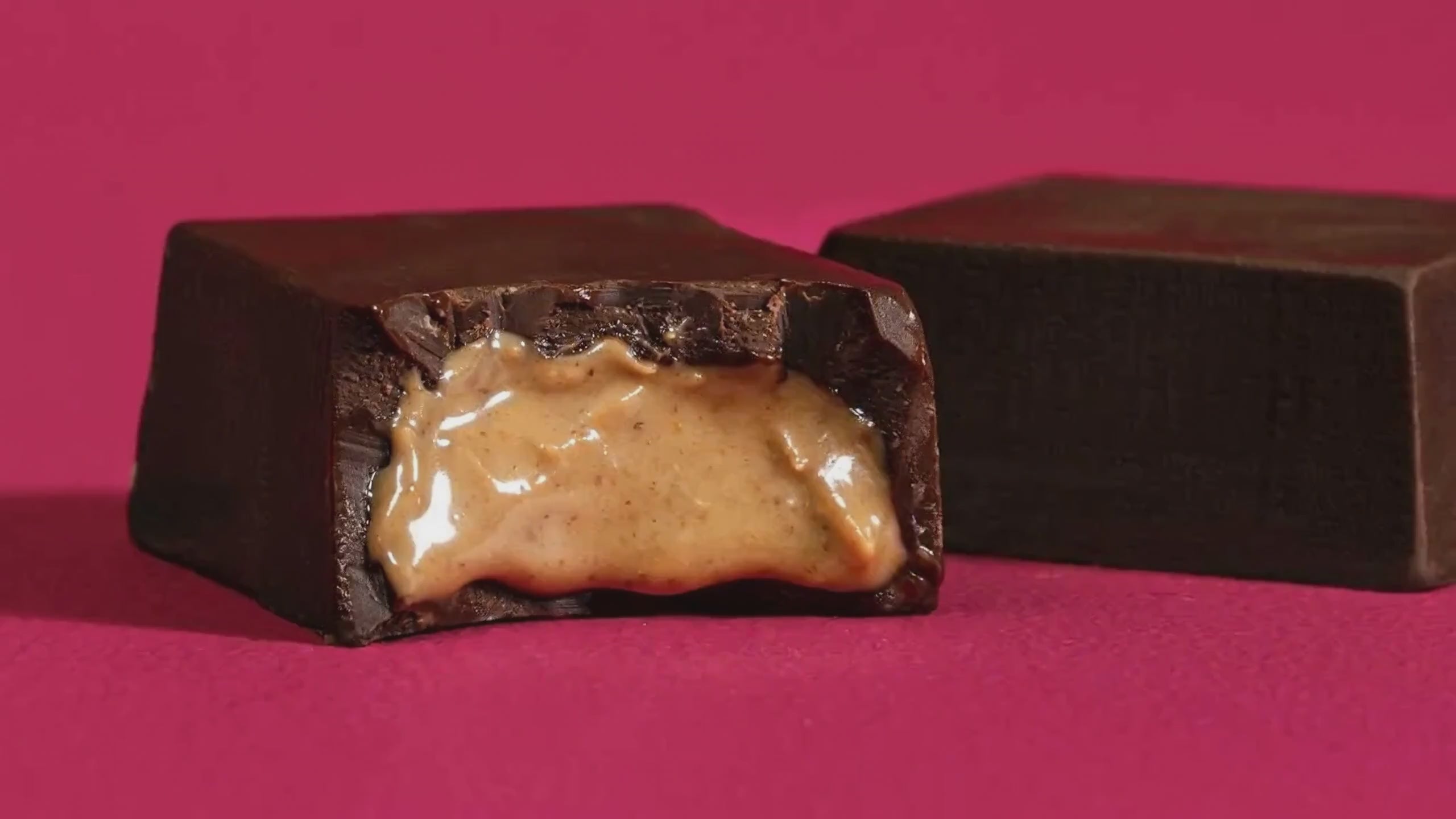 Almond Butter Chocolate Bar, close-up video of unwrapped bar showing creamy almond butter filling in 81% dark chocolate, by Coracao